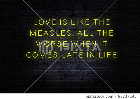 Wise quote. Neon inscription against brick wall 65237143
