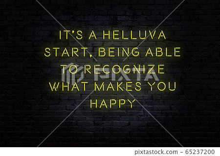 Wise quote. Neon inscription against brick wall Wise quote. Neon inscription against brick wall 65237200