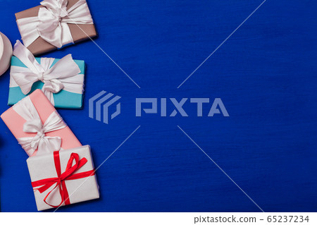 Multi-colored gifts on the birthday party background for inscriptions 65237234