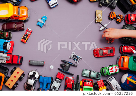 Lots of children's car toys for child development games on a background 65237256