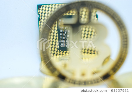 Closeup of physical bitcoin and computer cpu processor Closeup of physical bitcoin and computer cpu processor 65237921