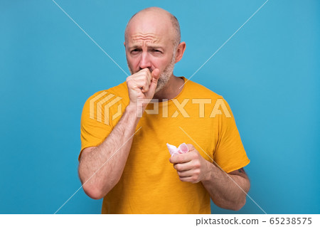 Mature caucasian man coughing because of flu or grippe Mature caucasian man coughing because of flu or grippe 65238575