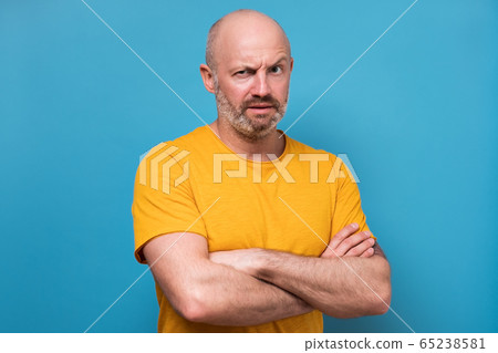 mature man looking with mistrust does not believe in news mature man looking with mistrust does not believe in news 65238581