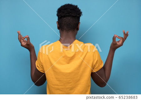 african american man turning back having relaxation while meditating african american man turning back having relaxation while meditating 65238683