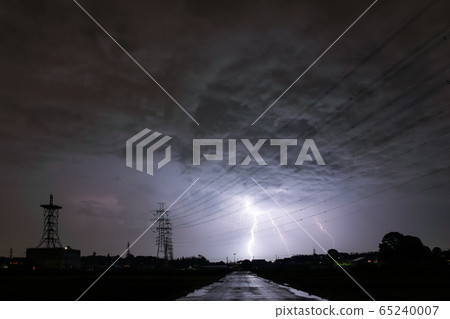 Road shining illuminated by power lines and thunder 65240007