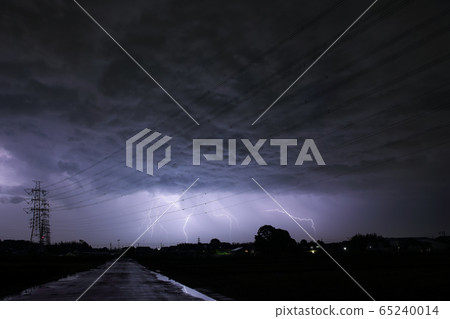 Road shining illuminated by power lines and thunder 65240014