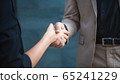 Two confident business man shaking hands during a 65241229