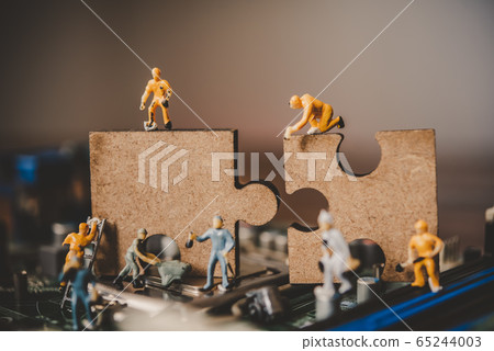 Miniature people or small figure worker on puzzles 65244003