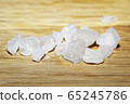 Sea salt on wooden surface. Refined salt, close-up 65245786