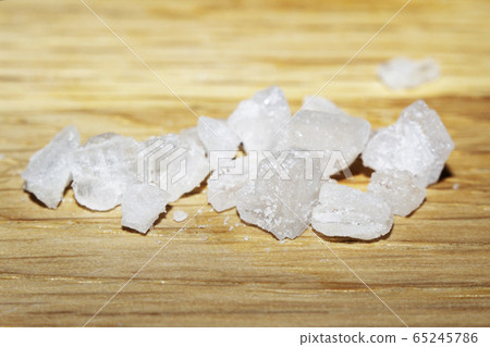 Sea salt on wooden surface. Refined salt, close-up Sea salt on wooden surface. Refined salt, close-up 65245786