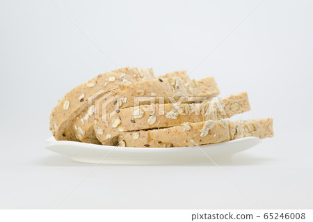 whole wheat with oat bread sliced on white plate whole wheat with oat bread sliced on white plate 65246008