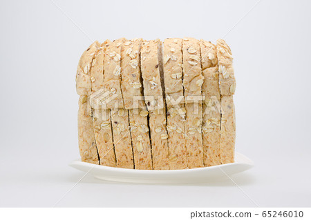 whole wheat with oat bread sliced on white plate 65246010