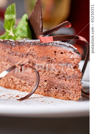 The Sacher cake, Sachertorte. Austrian chocolate cake, consisting of two plates of chocolate sponge cake and a thin layer of apricot jam 65250351