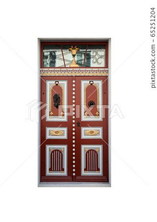 Ancient red wooden door with  carved decoration 65251204