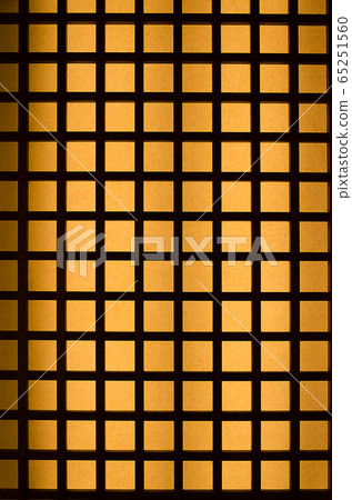 Orange light through black wood square pattern 65251560