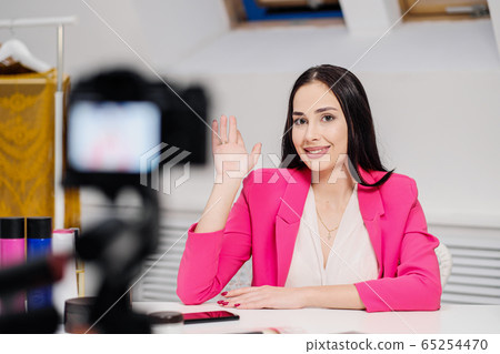 Female vlogger freelancer streams. The camera is close-up. View through the camera screen. Female vlogger freelancer streams. The camera is close-up. View through the camera screen. 65254470