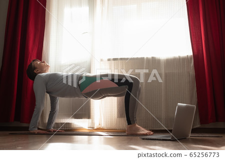 woman practices yoga asana purvottanasana or upward facing plank full pose woman practices yoga asana purvottanasana or upward facing plank full pose 65256773