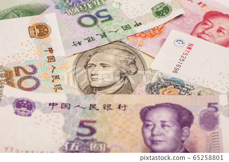 Ten dollar bill surrounded by Chinese Yuan Ten dollar bill surrounded by Chinese Yuan 65258801