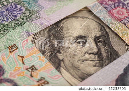 Hundred dollar bill surrounded by Chinese Yuan Hundred dollar bill surrounded by Chinese Yuan 65258803