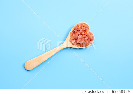 Pink himalayan salt in heart shape wooden spoon on Pink himalayan salt in heart shape wooden spoon on 65258969
