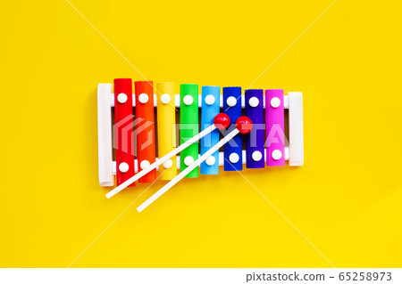 Colorful xylophone on yellow background. 65258973