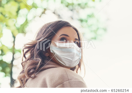 Stressed nervous woman in protective mask looking 65260254