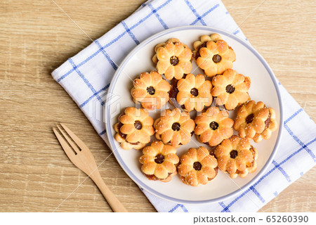 Cracker with pineapple jam (flower shape) on plate with fork ready to eating, Thai snack, Top view 65260390