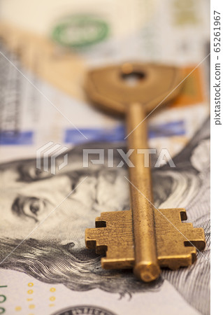 Closeup of key on hundred dollar bills Closeup of key on hundred dollar bills 65261967