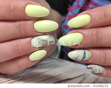 Trendy manicure design on a beautiful background. Trendy manicure design on a beautiful background. 65266255