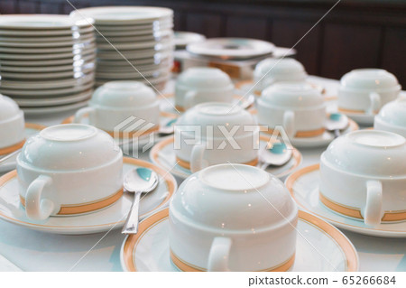 Group of ceramic cup and plates stacked on the table for tea or coffee service Group of ceramic cup and plates stacked on the table for tea or coffee service 65266684