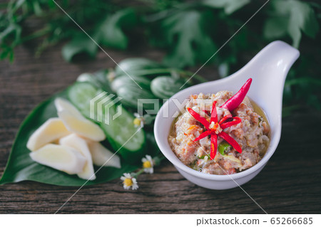 Crabs Roe in Coconut Chili Dip with vegetables on wood background Crabs Roe in Coconut Chili Dip with vegetables on wood background 65266685