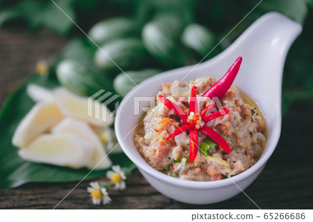 Crabs Roe in Coconut Chili Dip with vegetables on wood background Crabs Roe in Coconut Chili Dip with vegetables on wood background 65266686