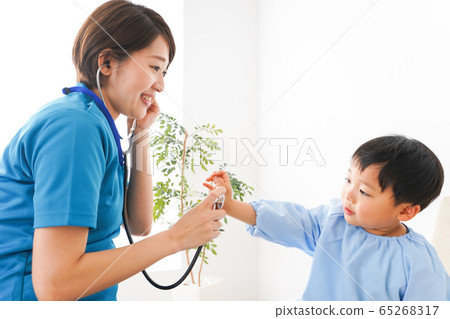 A young nurse examining a child 65268317