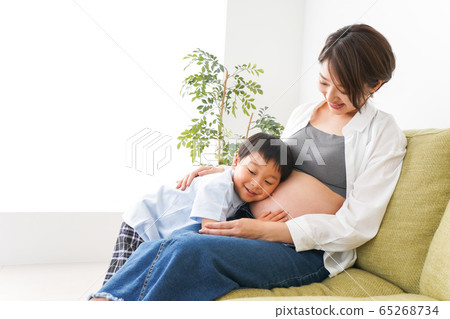 Little boy listening to the beating of a baby Little boy listening to the beating of a baby 65268734