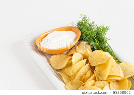 chips with sour cream and dill sauce isolated chips with sour cream and dill sauce isolated 65268962