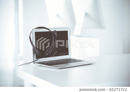 Call center and communication support, customer service help desk. VOIP headset on laptop computer 65271722