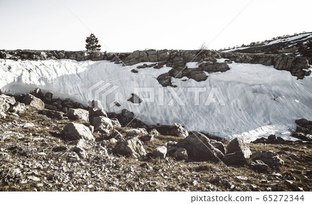 Landscape on the mountain stones, snow, under the bright sun, in retro style Landscape on the mountain stones, snow, under the bright sun, in retro style 65272344