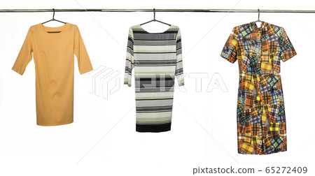 A collection of elegant dresses, isolated on white background. Photo on the crossbar and shoulders 65272409