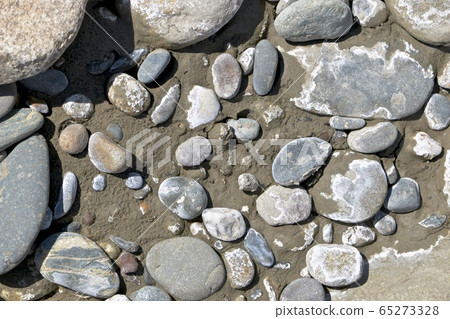 Different stones on wet river sand mixed with Different stones on wet river sand mixed with 65273328