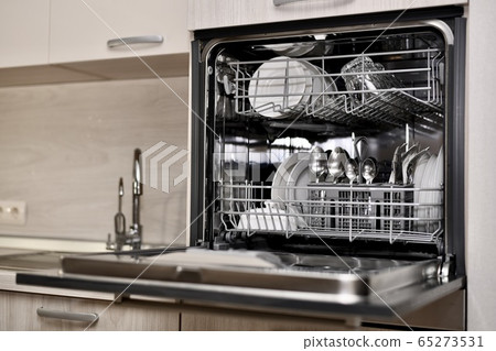 A dishwasher with utensils opened, installed at A dishwasher with utensils opened, installed at 65273531