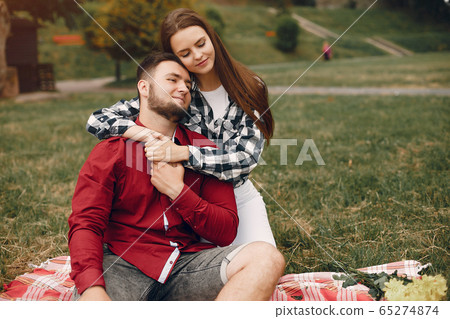 Beautiful couple spend time in a summer park 65274874