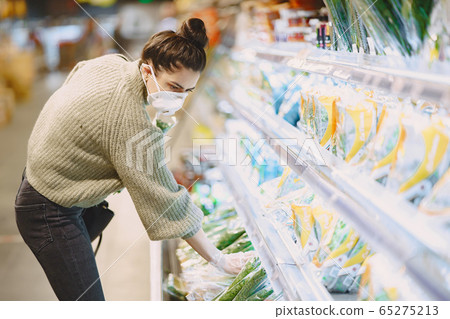Woman in a respirator in a supermarket Woman in a respirator in a supermarket 65275213