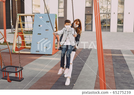 Family in a mask standing on the street 65275239