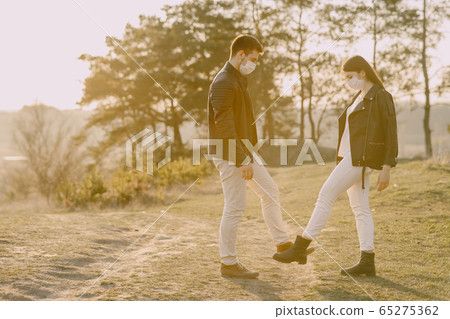 People in a masks standing in a spring forest People in a masks standing in a spring forest 65275362