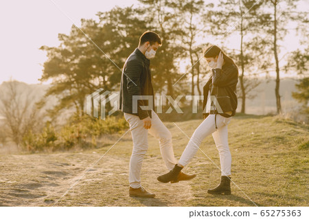 People in a masks standing in a spring forest People in a masks standing in a spring forest 65275363