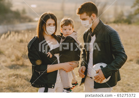 Stylish family walking on a spring field Stylish family walking on a spring field 65275372