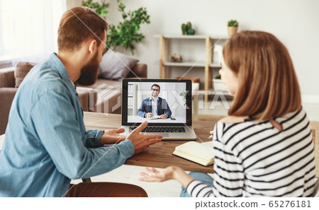 Couple making video call to financial counselor. 65276181