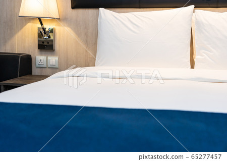 White comfortable pillow and blanket on bed decoration in bedroom White comfortable pillow and blanket on bed decoration in bedroom 65277457