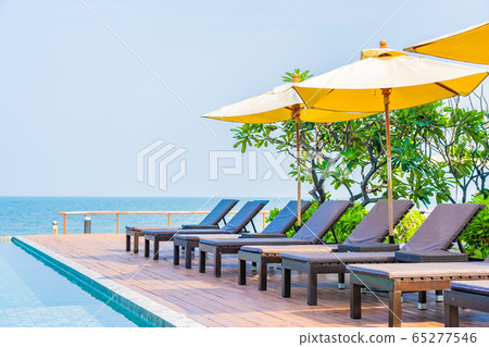 Beautiful empty chair umbrella around outdoor swimming pool in hotel resort for travel Beautiful empty chair umbrella around outdoor swimming pool in hotel resort for travel 65277546