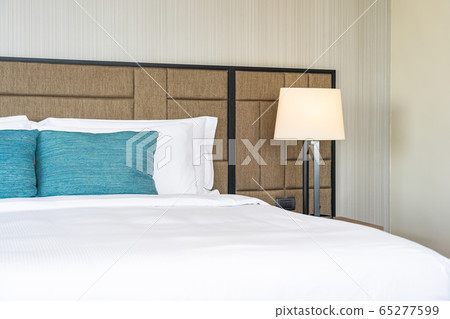 White comfortable pillow on bed decoration interior 65277599